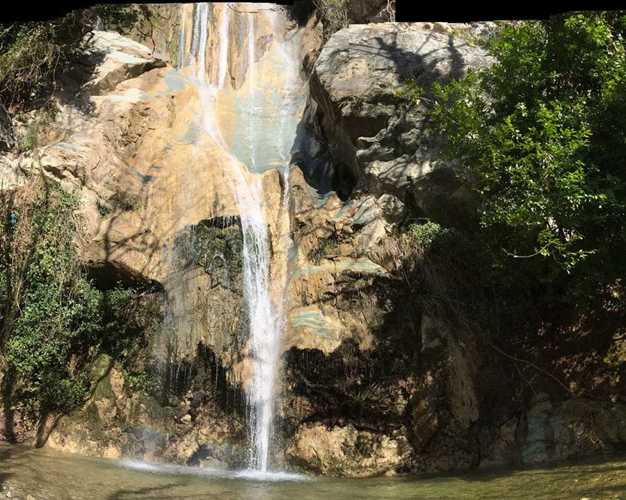 waterfall in nature at 'Eleonas' with trees on the both sides